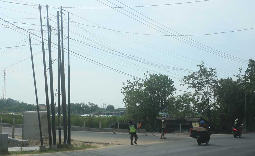 BERGEROMBOL SATU TITIK: Tiang provider di Jalan Soekarno-Hatta Tuban hingga Selasa (27/2) belum juga dipindahkan.