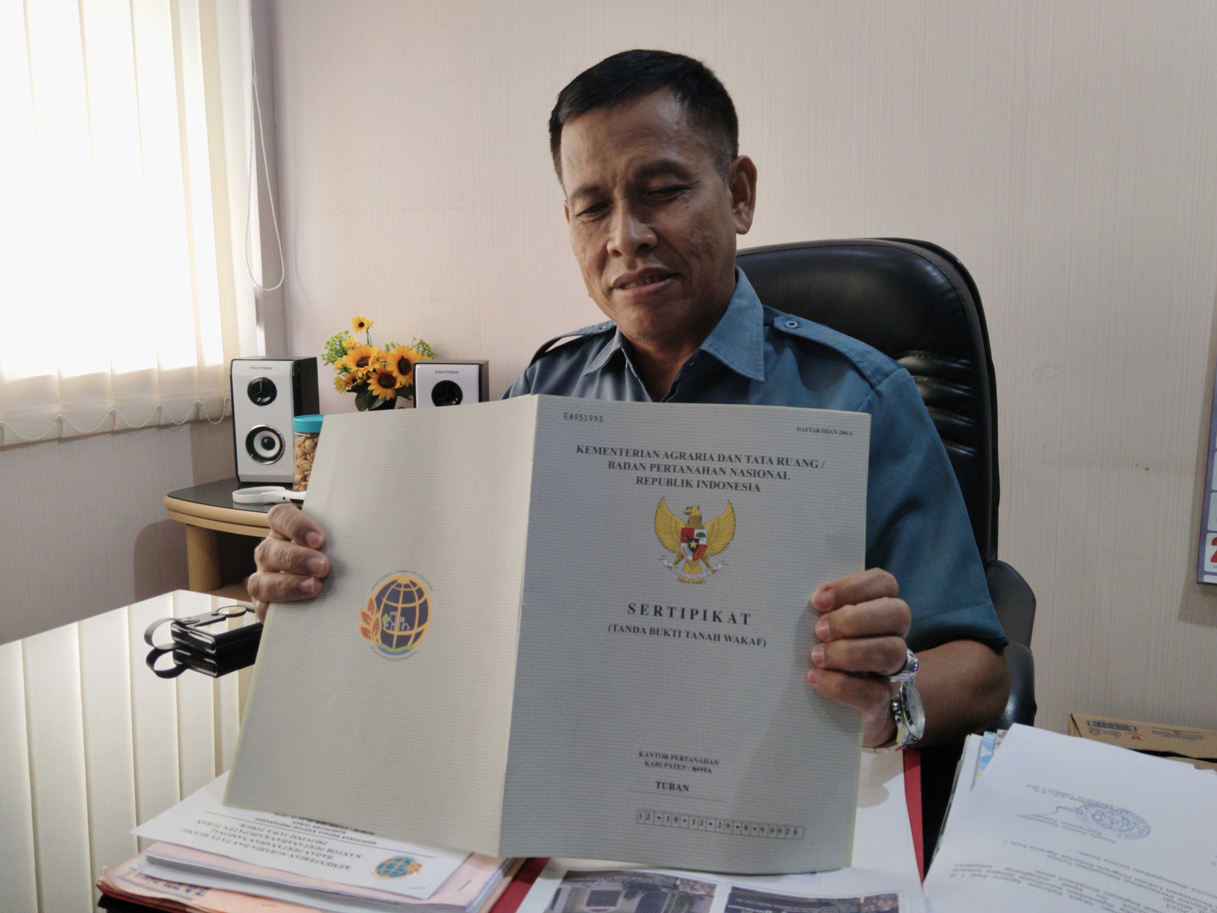 Kasi Penetapan Hak dan Pendaftaran Badan Pertanahan Nasional (BPN) Tuban Kacung Efendi saat menunjukkan salah satu sertifikat tanah wakaf yang sudah terbit.