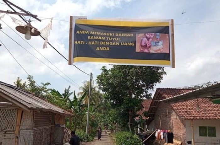 Banner bertuliskan Daerah Rawan Tuyul yang dipasang di salah satu desa di Jember.