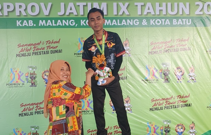 Purnomo Septiyano, atlet biliar asal Kabupaten Tuban bersama medali emas yang dikalungkan di lehernya, kemarin (2/7).