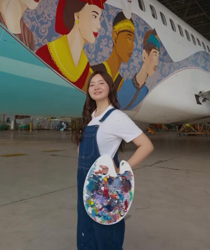 Erika dan lukisan di pesawatnya