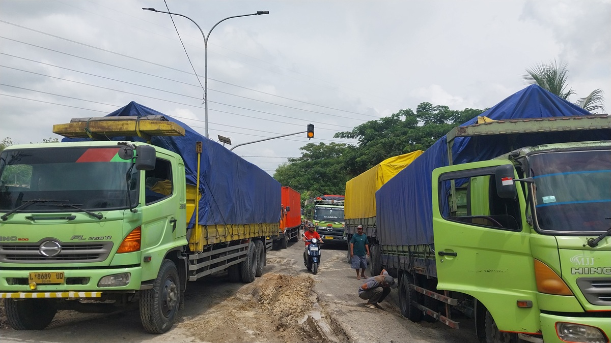 Karena kondisi jalan lingkar selatan rusak parah, butuh perjuangan berat bagi truk untuk melintas. Kerusakan terparah di Desa Prunggahan Kulon, Kecamatan Semanding.