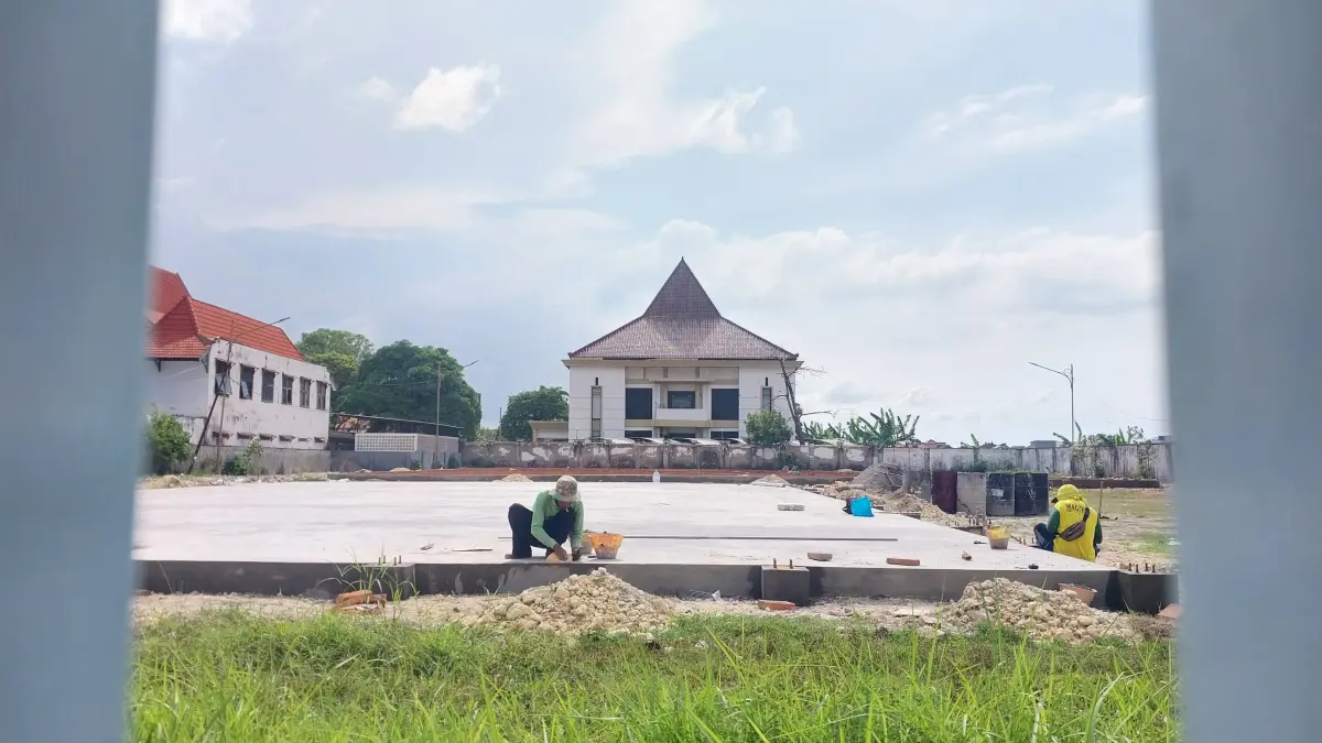 Pekerja proyek mulai pengerjaan finishing lantai sarana olahraga di utara gedung DPRD Tuban. (M. MAHFUDZ MUNTAHA/RADAR TUBAN)