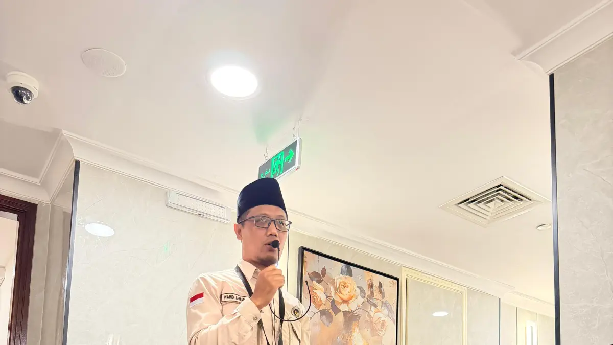 Pembimbing ibadah kloter 27, Wahid Ahmad Ali membimbing jemaahnya di lorong kamar Hotel Rua Al Massi, Kamis (7/5).