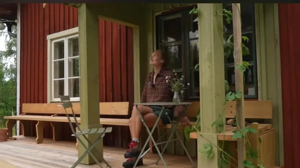 Rosie duduk santai di teras rumah tradisionalnya di tengah hutan Swedia. (Tangkapan layar Youtube THE PILLOW)
