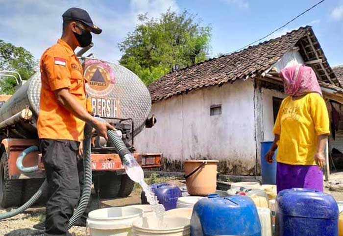 PENUHI KEBUTUHAN: Personel BPBD Kabupaten Probolinggo mendistribusikan air bersih di Desa Sumberkare, Kecamatan Wonomerto. Saat ini stok logistik masih mencukupi. (Foto : Achmad Arianto/Jawa Pos Radar