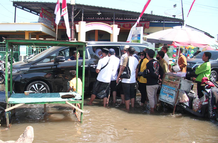 MUMPUNG ADA GUBERNUR: Banjir rob yang terjadi di Desa Kalibuntu. Inset, Gubernur Khofifah di dalam mobil saat disambut warga Kalibuntu.