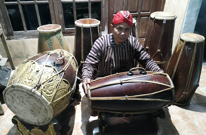 KOLEKSI: Bedjo Santoso dengan sejumlah jenis gendang koleksinya. Selain penabuh, ia juga soerang perajin gendang.