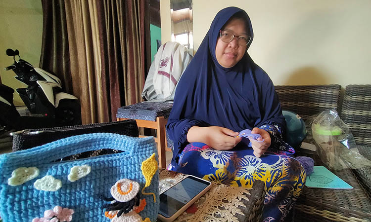 PESANAN TAS: Atikah, 43, saat merajut pesanan tas dari pelanggannya.