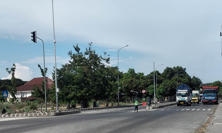 DIKELUHKAN: Lalu lintas di sekitar Exit Tol Grati. Di lokasi ini masih kerap ditemui truk yang parkir sembarangan.