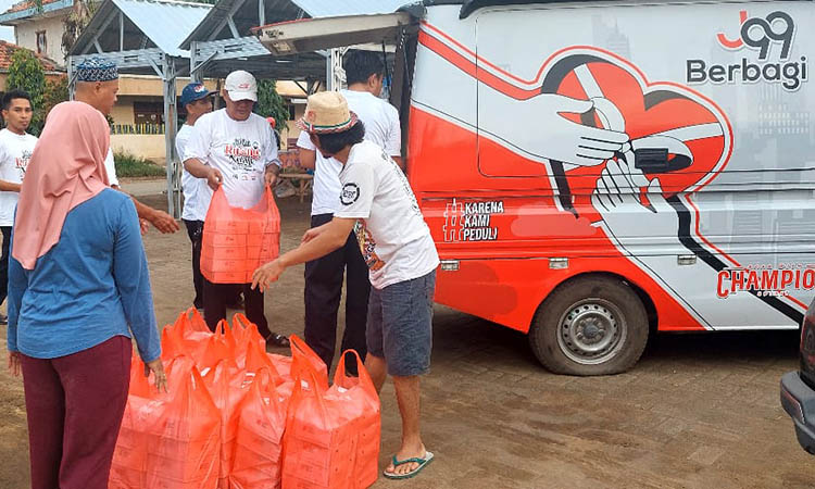 MERINGANKAN: Sejumlah petugas dari Juragan99 Foundation bersama Forsijama, menemui sejumlah korban banjir di Kecamatan Dringu. Mereka membawa bantuan untuk berbuka puasa.
