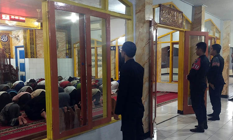 MAKIN KETAT: Sejumlah petugas keamanan siaga ketika sejumlah warga binaan Lapas Kelas IIB Pasuruan, melakukan salat tarawih, Senin (25/3) malam.