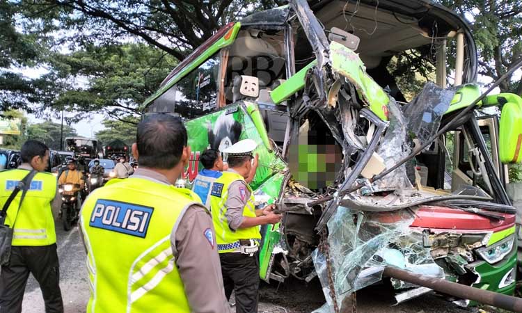 Petugas saat hendak mengevakuasi jenazah sopir bus Restu yang terjepit di ruang kemudi. (Rizal Syatori/ Radar Bromo)