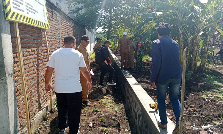 TPT: Bendahara Desa Kalisalam Ahmad Choirul Anwar (kaus putih) bersama Perangkat Kecamatan Dringu mengecek pembangunan TPT di Desa Kalisalam.