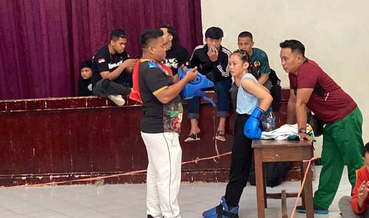 KELAS JUNIOR: Robiatul Adawiyah mendapat pengarahan dari pelatihnya saat bertanding di kelas 48 kilogram junior.