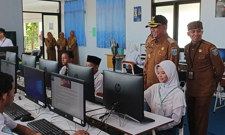 PANTAU: Pj Bupati Probolinggo H Ugas Irwanto (bertopi) saat melakukan peninjauan secara langsung proses ANBK di SMP 1 Kraksaan, Senin (9/9).