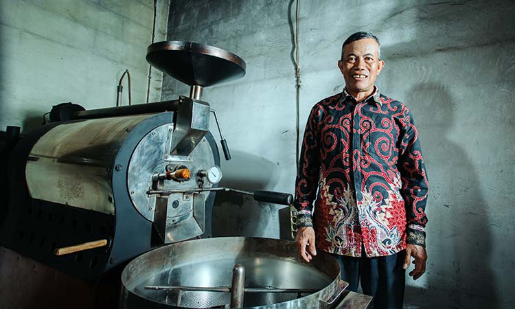 OLAH KOPI: Muhammad Rasyid menunjukkan mesin pengolahan kopi yang memanfaatkan listrik dari PLTMH di Desa Andung Biru, Kecamatan Tiris, Kabupaten Probolinggo.