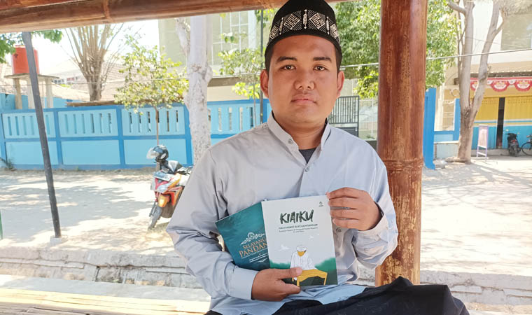 SANTRI: Mhaulana Aminullah saat berada di Ponpes Nurul Jadid Paiton sembari memegang salah satu hasil karya tulis ilmiahnya.
