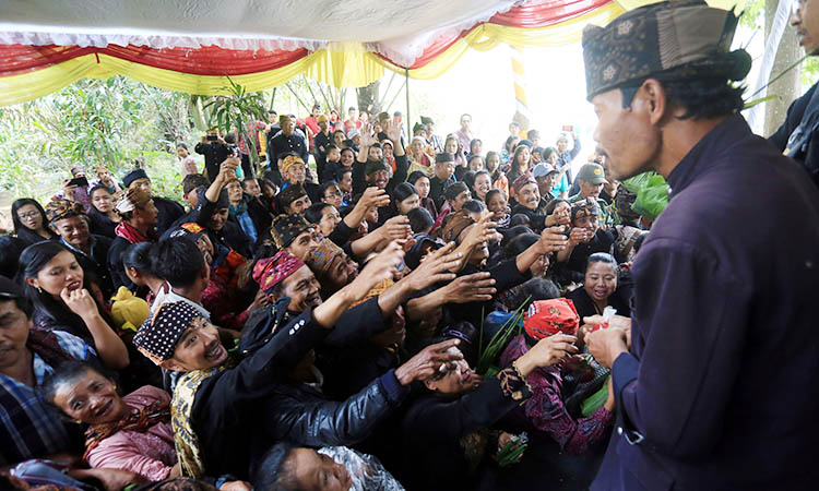 SENANG: Kegembiraan warga Desa Sapikerep, Kecamatan Sukapura saat berebut mendapatkan ubo rampe dalam upacara adat Unan-Unan.
