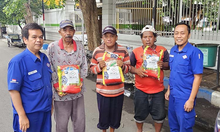 BAGI DI JALAN: Selain berbagi kebahagiaan dengan masyarakat sekitar perusahaan, PT PAI juga membagikan langsung paket beras kepada mereka yang membutuhkan di pinggir jalan di Kota Probolinggo.
