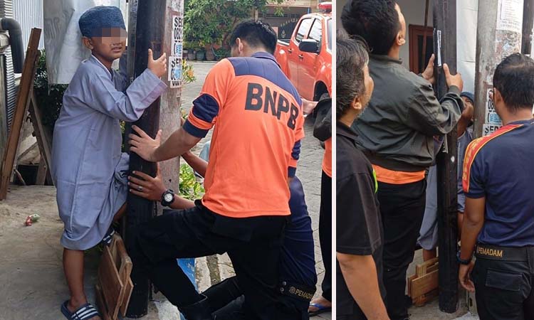 EVAKUASI: Petugas BPBD saat berupaya mengeluarkan kaki kiri San yang terjepit tiang listrik dan wifi di Bugul Kidul, Pasuruan.