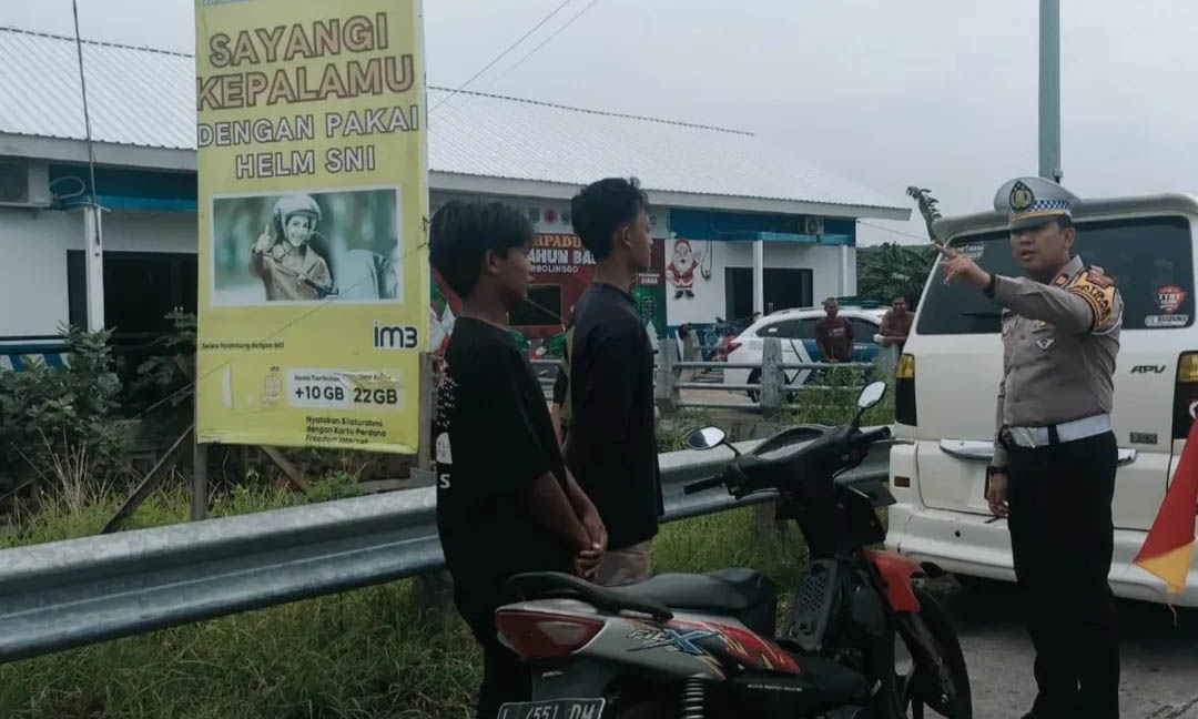 MELANGGAR: Petugas menindak pengendara motor yang melakukan pelanggaran di ruas jalan pantura Gending.
