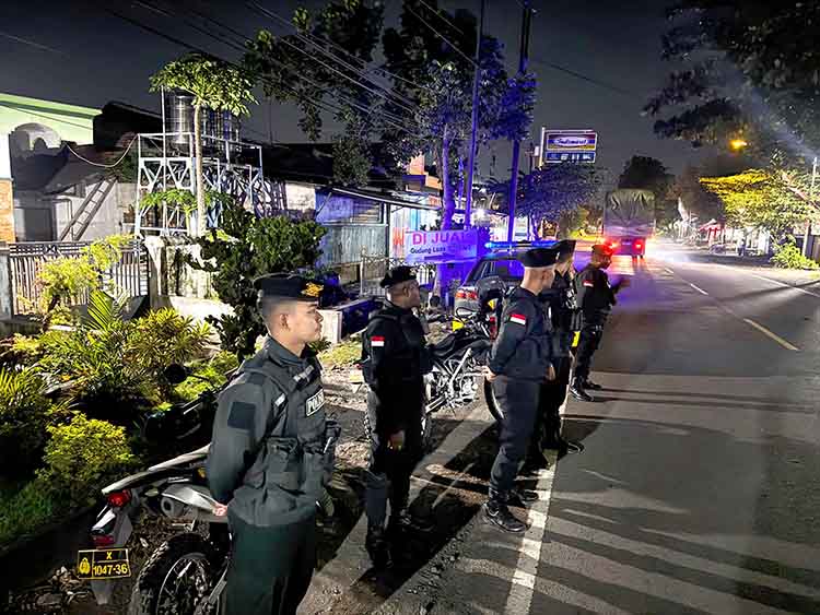 JAGA KEAMANAN: Sejumlah anggota Polres Probolinggo Kota berjaga di Jalan K.H. Hasan Genggong yang kerap dijadikan arena balap sepeda.