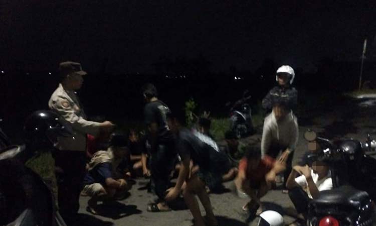 Anggota Polsek Kraksaan saat membubarkan remaja yang menggelar aksi balap sepeda onthel jelang sahur, Minggu (9/3).