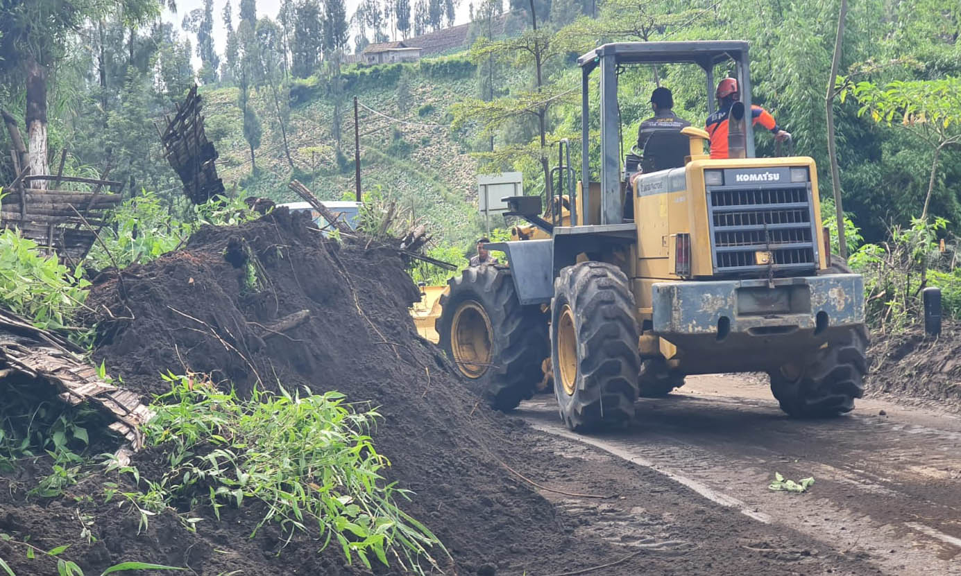 TEBAL: Alat berat yang dikerahkan untuk mengevakuasi material tanah longsor di ruas jalan Dusun Jurang Jontro, Desa Wonokerto, Kecamatan Sukapura.