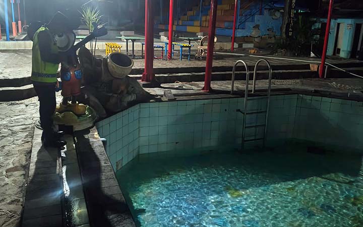 DITUTUP: Polisi saat memeriksa lokasi bocah tewas tenggelam di kolam renang Tirto Kencono, Pasuruan.