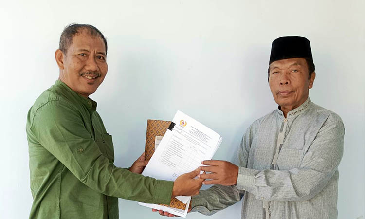SERAHKAN: Mamat Aryo Setiawan, bakal calon Ketua Koni Kabupaten Pasuruan saat menyerahkan berkas pendaftaran kepada Sekretaris KONI Kabupaten Pasuruan M. Muriyat.