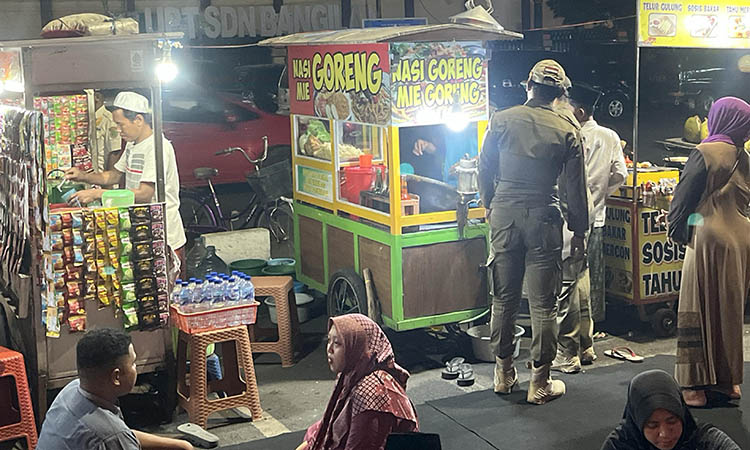 SISIR: Satpol PP saat melakukan penyisiran terhadap PKL yang berada di kawasan Alun-Alun Kota Pasuruan. Penyisiran dilakukan untuk memberi sinyal tindakan tegas jika mereka kedapatan melanggar.