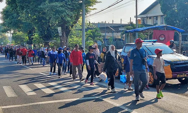 KEBERSAMAAN: Peserta jalan sehat menempuh rute sepanjang 2,4 km dengan tertib.