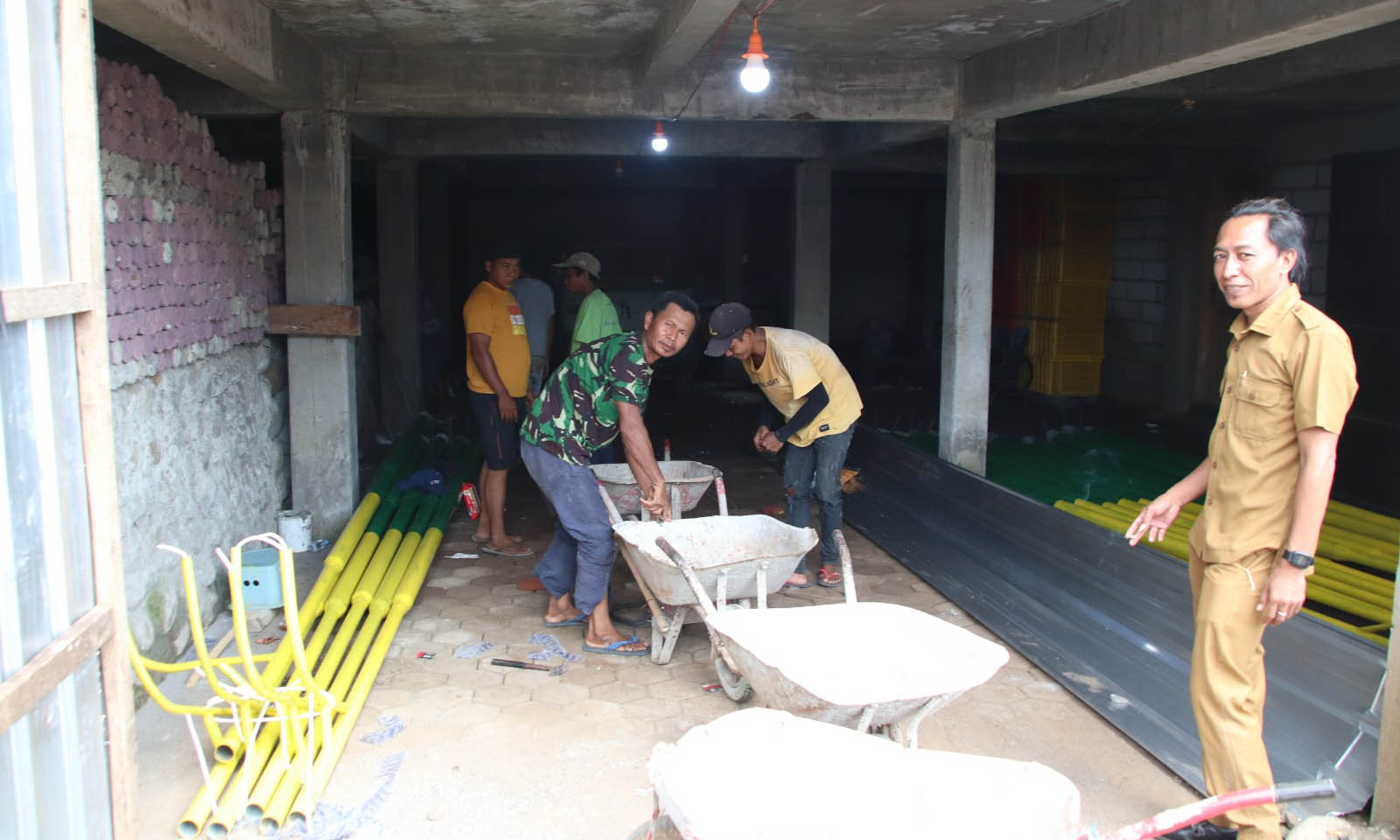 PROSES: Kepala Desa Patemon Kulon Muhammad saat memantau pembuatan PJU yang disiapkan untuk jalan di Dusun Krajan.