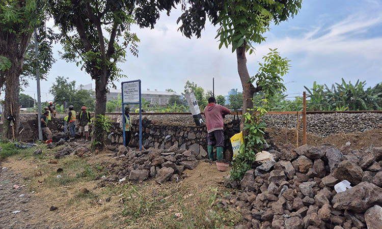 DIKEBUT: Pekerja tampak menggarap sisi selatan. Pembangunan tembok penahan jalur rel KA ini, tengah dipacu agar segera selesai.