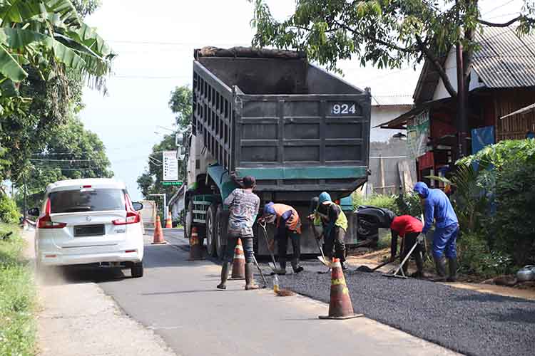 KONSTRUKSI: Sejumlah pekerja menggarap perbaikan jalan di Jalan Raya Lumbang, Desa Tandonsentul, Kamis (10/7).