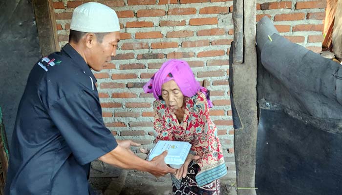 Petugas saat mengantar nasi kotak untuk sarapan lansia di Desa Pajaran, Rembang, Kabupaten Pasuruan.
