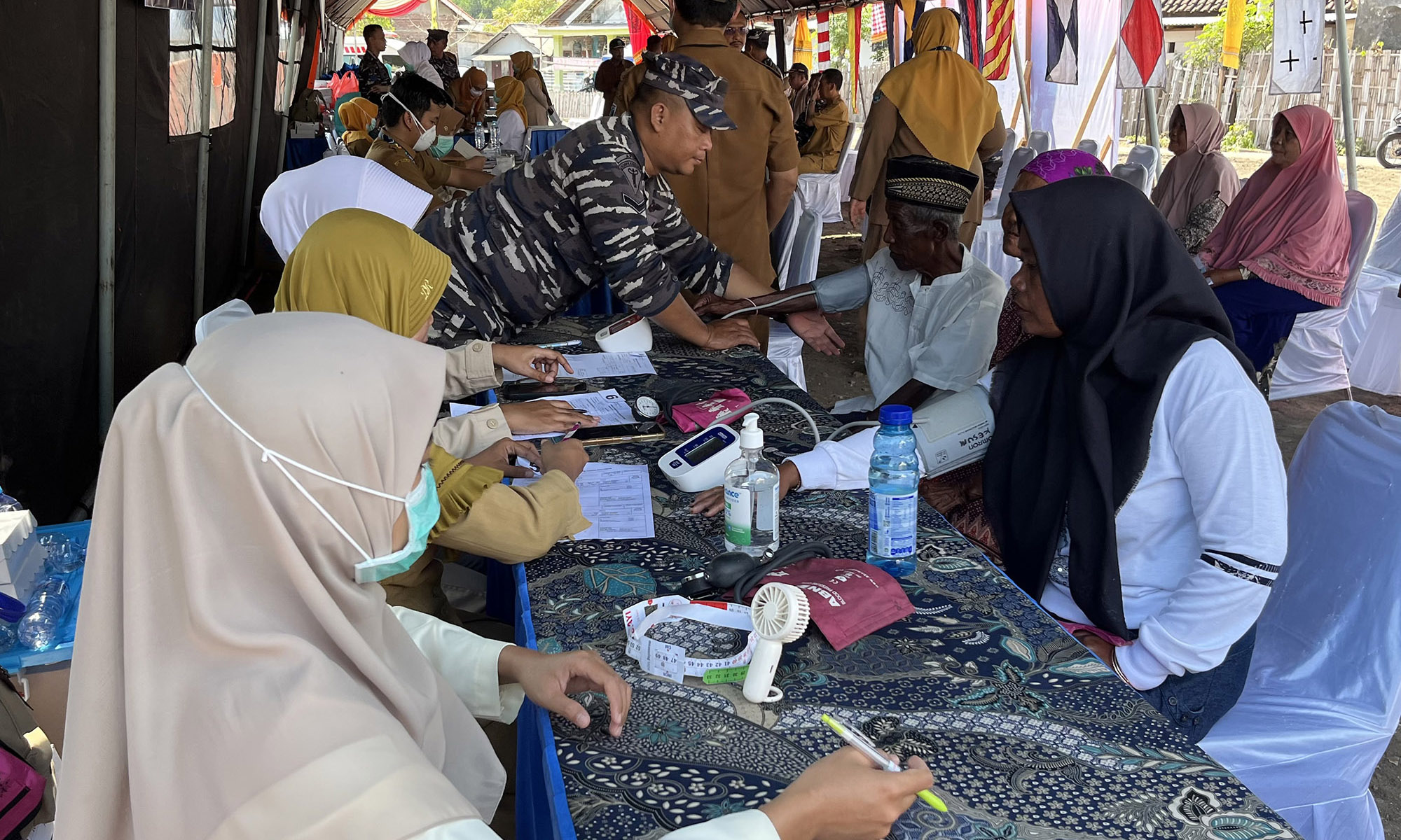 PENGECEKAN: Nakes dari Dinkes Kabupaten Probolinggo dan Diskes Lantamal V berkolaborasi mengecek kesehatan warga.