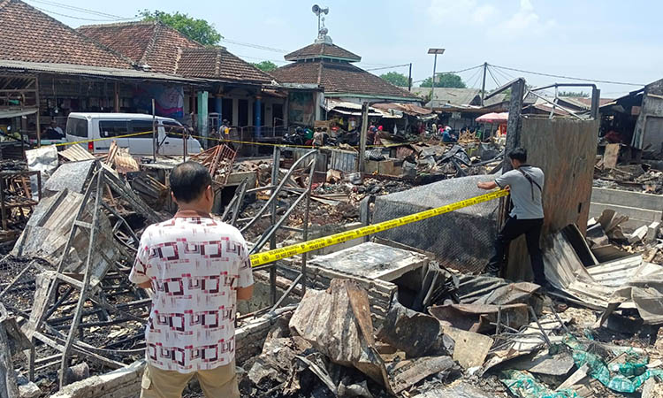PASANGI: Petugas kepolisian saat memasang police line tambahan. Hal ini dilakukan, untuk memperlancar proses pendalaman.