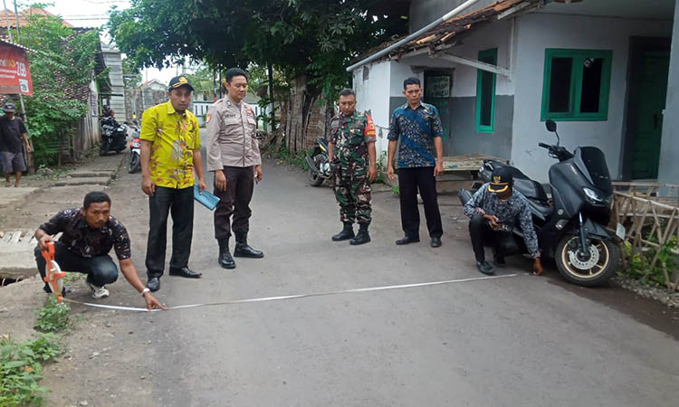 PENGECEKAN: Kepala Desa Widoro, Abdul Jalal (batik biru) saat berada di lokasi jalan aspal yang telah dibangun.