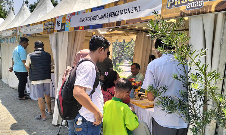 ANTRE: Pengunjung Pekan Raya Pasuruan 2025 saat mengantre layanan di stan Dispendukcapil Kabupaten Pasuruan.