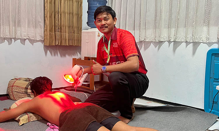 HARUS TEPAT: Muhammad Irfandi saat melakukan terapi atau penahan pada salah satu atlet di kabupaten Probolinggo yang cedera.