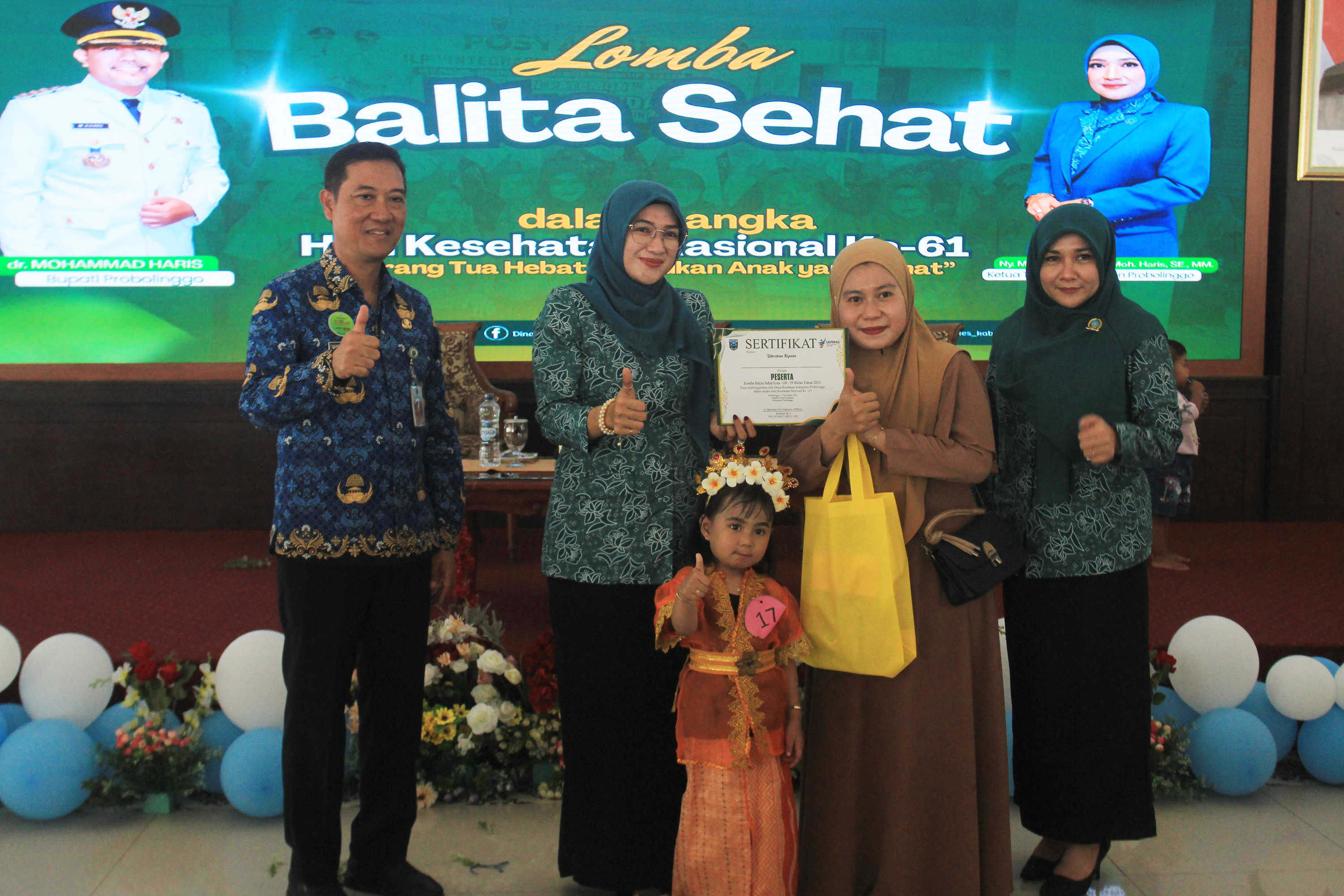 SIMBOLIS: Ketua TP PKK Kabupaten Probolinggo Ning Marisa Juwita Sari, S.E. didampingi Kepala Dinkes Kabupaten Probolinggo dan istri menyerahkan sertifikat dan suvenir kepada salah satu balita.