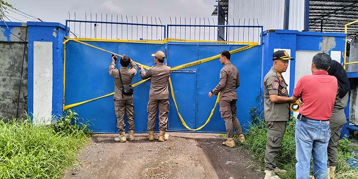 DITUTUP: Petugas Satpol PP saat melakukan penutupan pabrik arang briket di Purwosari, Kabupaten Pasuruan, Senin (24/11).