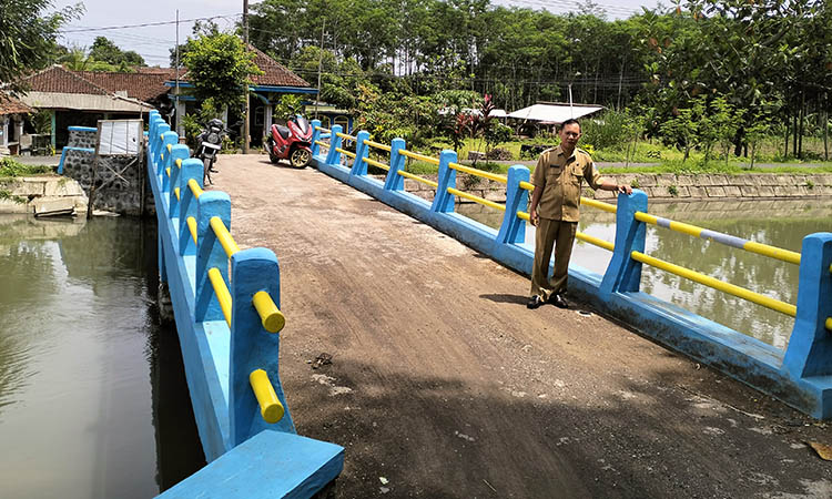 KOKOH: Sekretaris Desa Maron Kidul Lukman Hakim melewati jembatan di RT 6/RW 2, Dusun Brukan.
