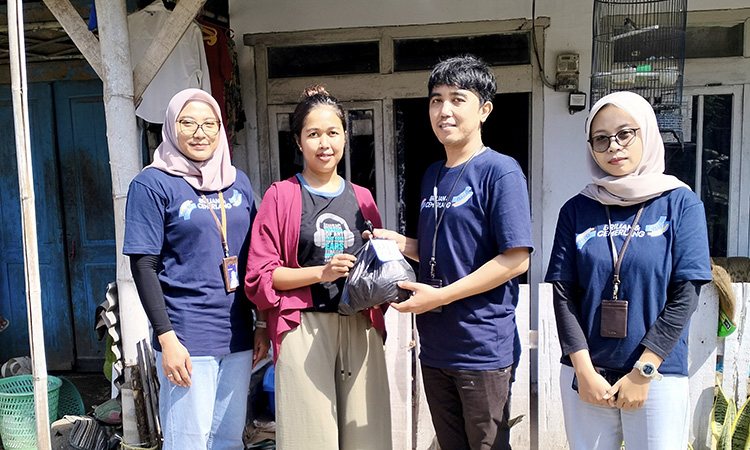 JALIN SILATURAHMI: Kepala Unit BRI Banyuanyar Egsi Mei Hapsari (kiri) memberikan paket sembako pada nasabah BRI Unit Banyuanyar Rohmawatunnisa.