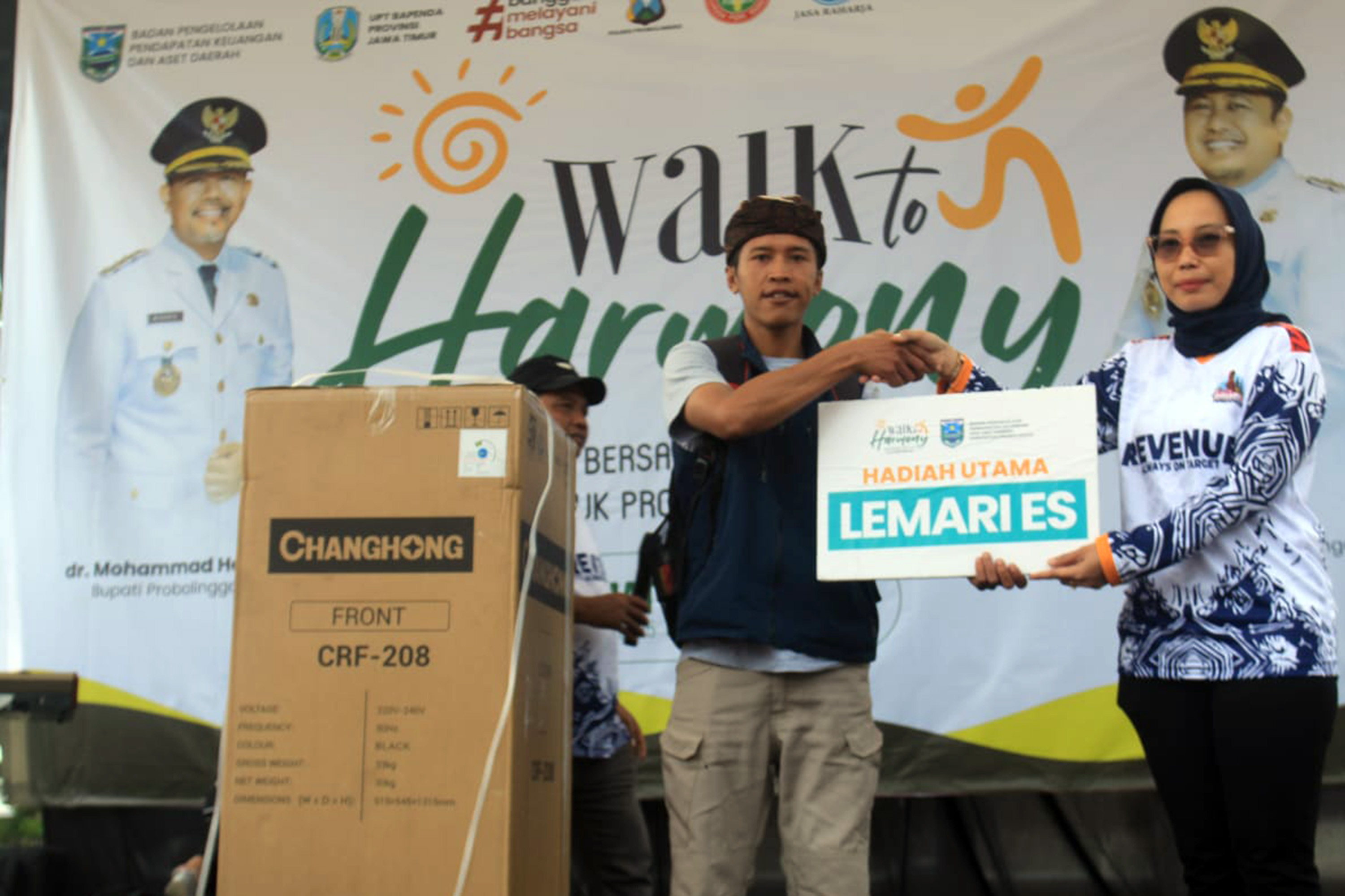 HADIAH: Kepala BPPKAD Kabupaten Probolinggo, Kristiana Ruliani menyerahkan hadiah utama jalan sehat berupa lemari es.