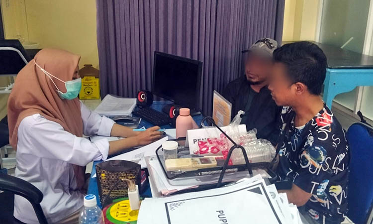 ASESMEN: Petugas konselor dari BNNK Pasuruan saat melakukan asesmen terhadap AS yang tengah didampingi salah satu keluarganya.