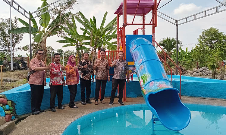 IKON DESA: Kepala Desa Brani Wetan Ir. Sujoko bersama undangan berfoto di samping seluncuran air (waterslide) usai peresmian ikon tematik desa berdaya.