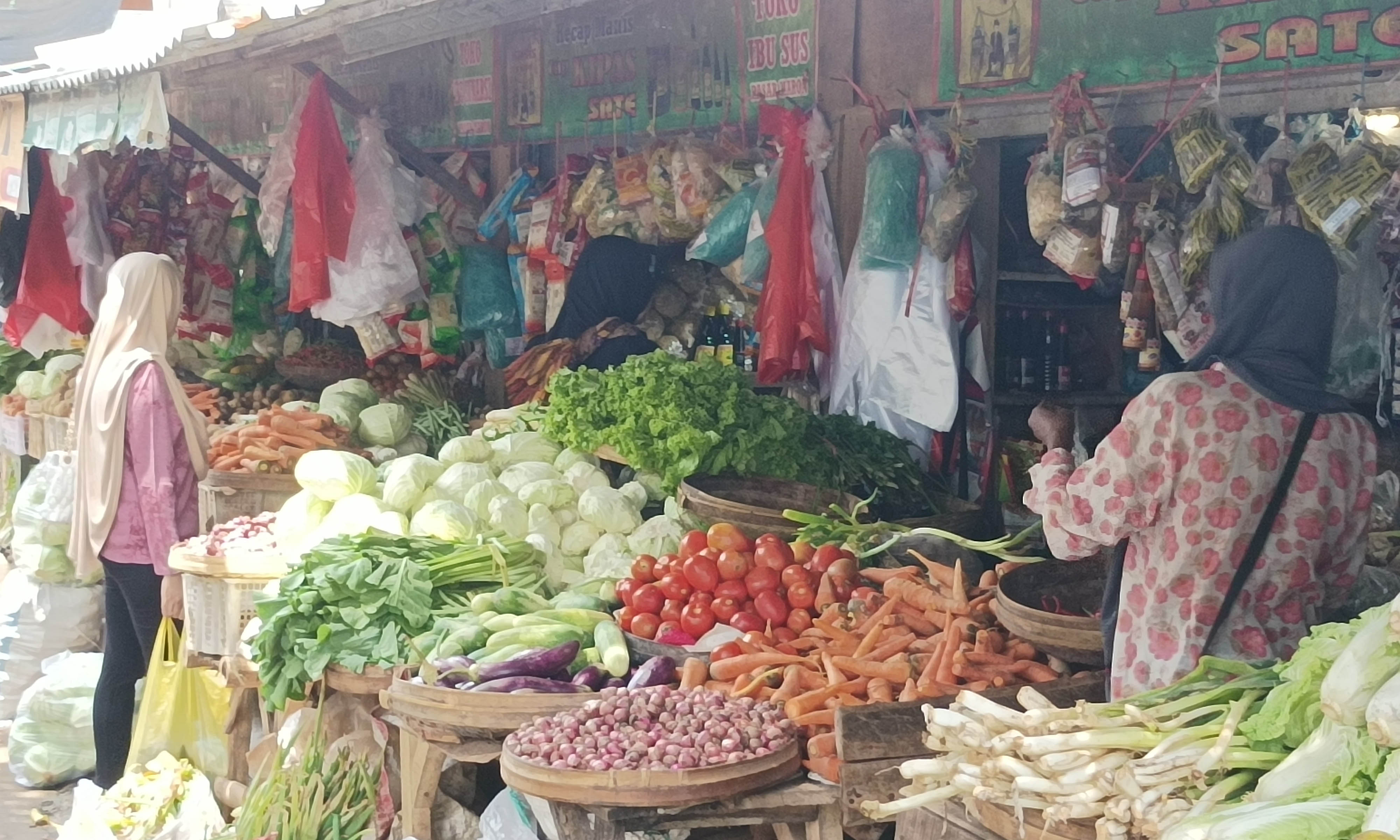 TERKENDALI: Suasana di Pasar Kraksaan saat pagi hari. Saat ini harga bahan pokok banyak yang turun.
